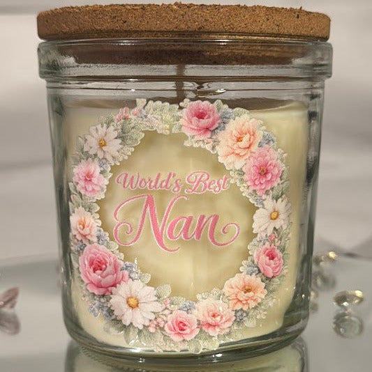 Candle in a glass jar with floral design and 'World's Best Nan' text on a white background